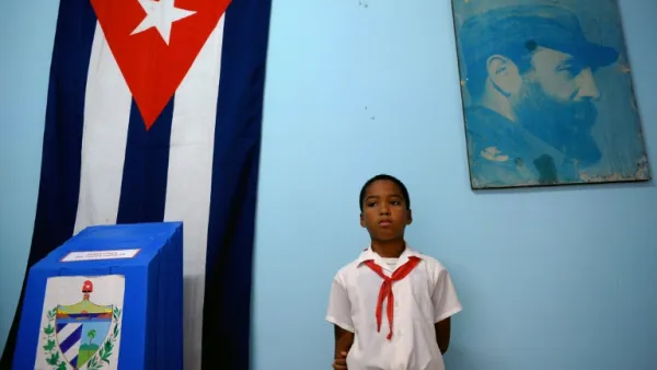 A schoolboy stands at a polling station in Havana during elections (AFP/File Photo)