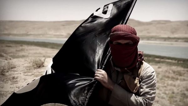 A Daesh militant carries his flag. (AFP/File)