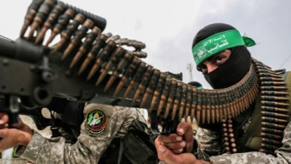 Fighters from the Ezzedine al-Qassam Brigades, the armed wing of the Palestinian Hamas movement, take part in a military show. (AFP)