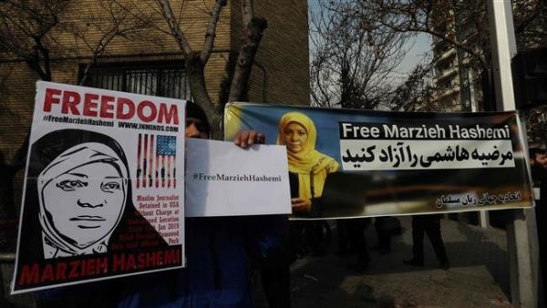 Iranians hold banners bearing messages that call for the release of US-born journalist Marzieh Hashemi, near the Swiss embassy in the capital, Tehran. (AFP/ File)