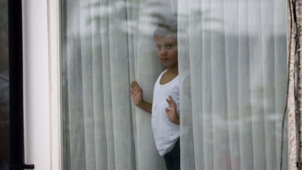 Child looking thru the window (AFP/File Photo)