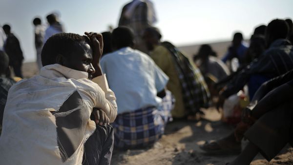 African migrants, including Ethiopians, wait near Obok, north of Djibouti's capital, for smugglers' boats to cross the Gulf of Aden into Yemen. (AFP/Tony Karumba)