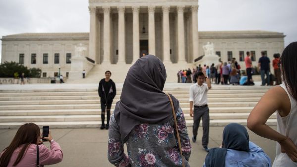 A woman wearing a hijab stands outside the court (AFP/File Photo)
