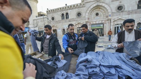 People buying clothes in front of Al-Husseini Mosque on December 9, 2016, in downtown Amman. (Shutterstock) People buying clothes in front of Al-Husseini Mosque on December 9, 2016, in downtown Amman. (Shutterstock)