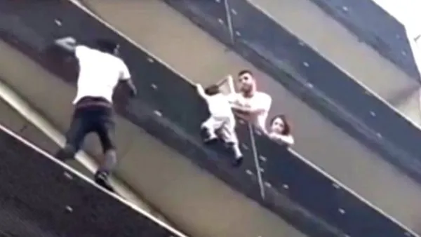  الطفل قد انزلق عمليا من الشرفة وتمسك بطرفها 