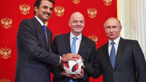FIFA president Gianni Infantino (centre) takes the ball from Russian president Vladimir Putin and passes it to Emir of Qatar Sheikh Tamim as a symbol of transfer of authority to Qatar for hosting the FIFA World Cup 2022. (AFP/ File Photo)