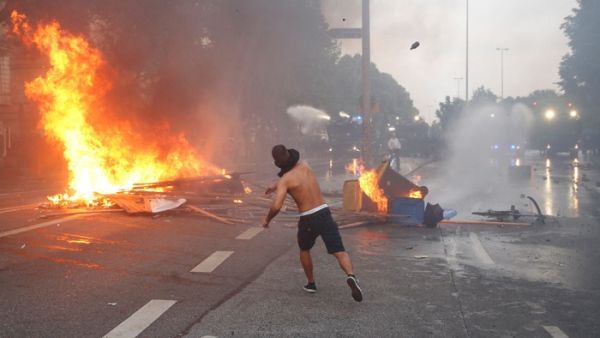 A protester throws a bottle at riot police in Hamburg last week. (Ronny Hartmann/ AFP) A protester throws a bottle at riot police in Hamburg last week. (Ronny Hartmann/ AFP)