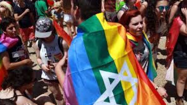 An Israeli with a rainbow-colored flag draped around his shoulders attends the annual gay pride parade in the Israeli coastal city of Tel Aviv on June 12, 2015. (AFP/Gil Cohen-Magen)
