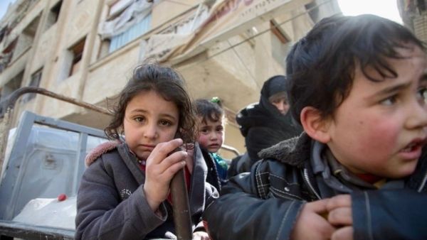 Syrian children in back of truck in besieged Eastern Ghouta (AFP/File Photo)