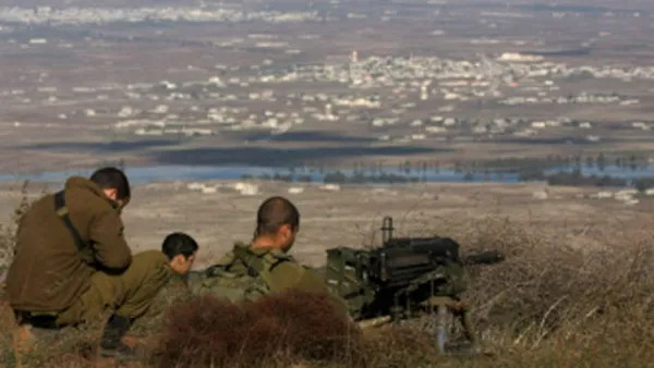 Israeli soldiers stand in an abandoned military outpost overlooking the Israeli-occupied Golan Heights. (AFP/File)