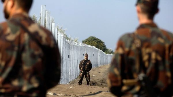Hungarian soldiers stand guard at the border line between Serbia and Hungary near Roszke village on September 13, 2015. (AFP/Peter Kohalmi)