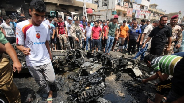 Iraqis inspect damage following a car bomb in Sadr City, Baghdad earlier today. (photo: AFP/Ahmad al Rubaye)