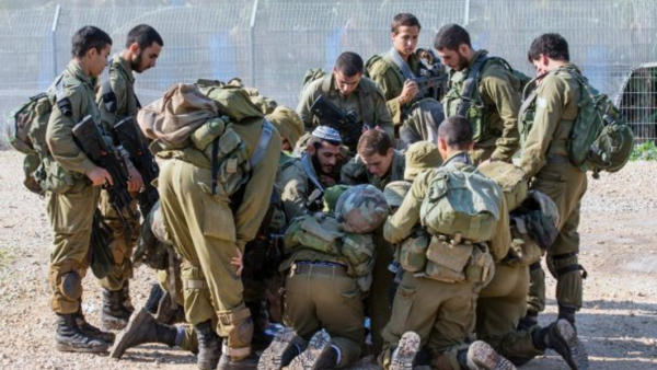A group of Israeli soldiers inspect a map near the Israel-Lebanon border. (AFP)