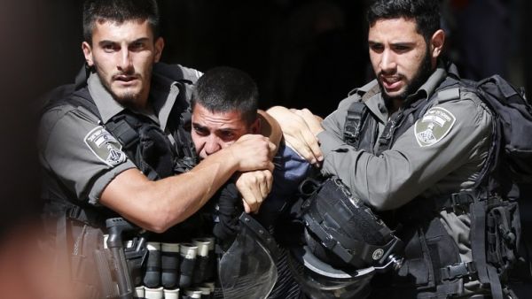Israeli soldiers arrest a young Palestinian man amid ongoing violence. (AFP/File)