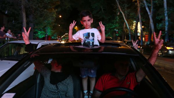 A family celebrates in the streets of Iran's capital Tehran after news of the recent nuclear deal.  (AFP/Atta Kenare)