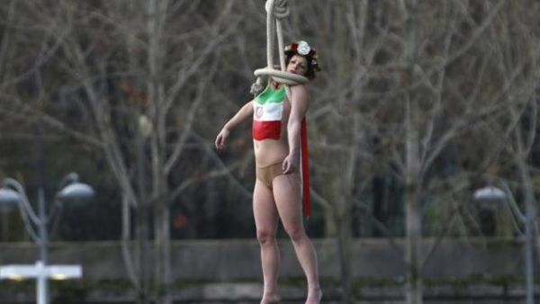 A Femen protester performs a mock hanging off a Parisian bridge (AFP/File)