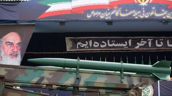  An Iranian surface to surface Zelzal missile is driven past portraits of Iran's late founder of the Islamic republic, Ayatollah Khomeini . (Image credit: Getty)