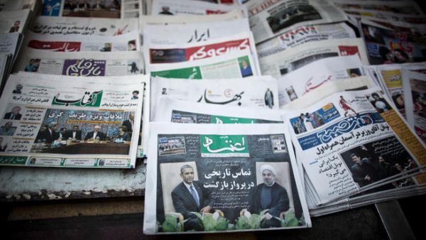 Iranian newspapers with pictures depicting Iranian and US leaders.  Iranians hope international sanctions that have suffocated the economy could be lifted if relations improve between Tehran and Washington. (Image credit: AFP)