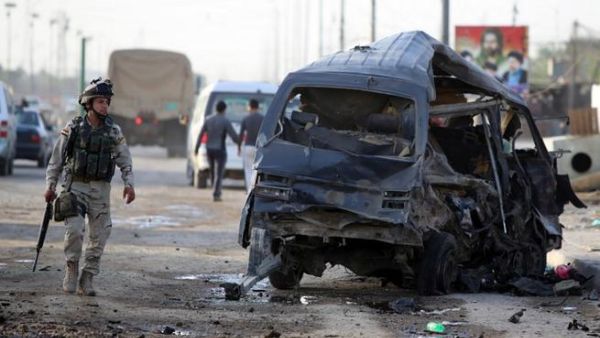 An Iraqi soldier inpects the remains of a vehicle at the scene of a car bomb explosion the previous days in Baghdad's Sadr City district on May 16, 2013 (Ahmad al-Rabaye/ AFP)