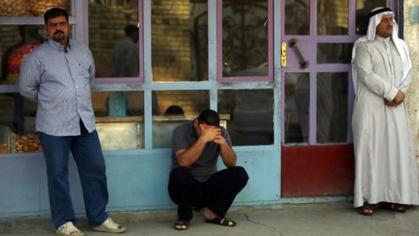 Iraqi men react to the death of family members in the Dora area of south Baghdad (Ahmad al-Rubaye / AFP)