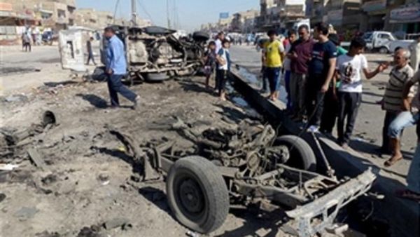 Iraqis inspect the site of a car bomb explosion in the impoverished district of Sadr City in Baghdad on July 29, 2013. (AHMAD AL-RUBAYE/AFP/Getty Images)