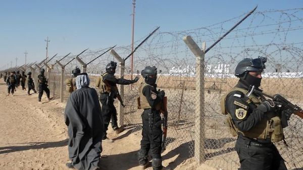 Iraqi SWAT forces stand guard outside Camp Ashraf, home to exiled Iranian opposition members. [AFP]