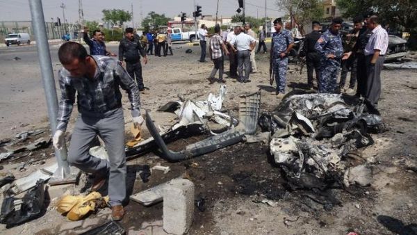 IRAQ, Kirkuk : Iraqi policemen and investigators inspect the remains of a car bomb that exploded outside the ministry of education in the northern Iraqi city of Kirkuk on August 22, 2013. AFP PHOTO MARWAN IBRAHIM IRAQ, Kirkuk : Iraqi policemen and investigators inspect the remains of a car bomb that exploded outside the ministry of education in the northern Iraqi city of Kirkuk on August 22, 2013. AFP PHOTO MARWAN IBRAHIM