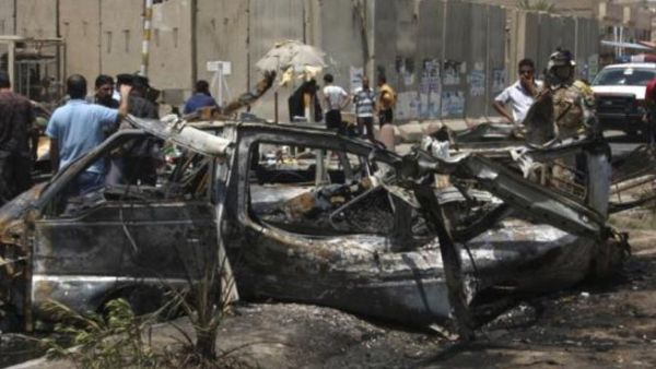 People inspect site of a car bomb attack in Iraq. [presstv]