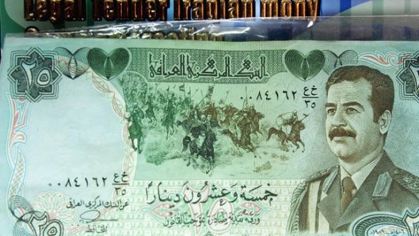 An old Iraqi bank note bearing a picture of Saddam Hussein is displayed in Baghdad. A stash of $27 billion USD at the Moscow airport could have belonged to the ex-dictator. (Image credit: Getty)