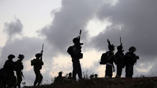 Israeli soldiers stand guard during a tense situation. (Image credit: AFP)