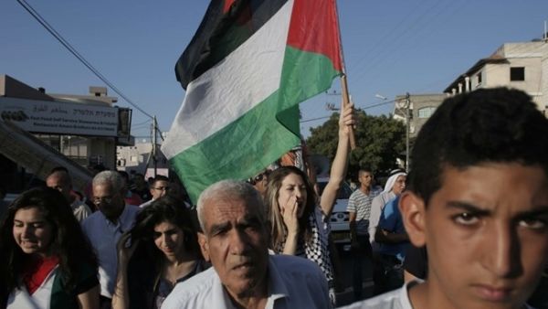 Israeli Arabs march during a demonstration to protest against the demolition of houses by Israeli authorities on June 15, 2015, in the town of Kfar Kana in northern Israel. (AFP/Ahmad Gharabli)