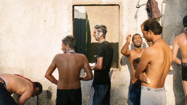 Showers of the makeshift refugee camp in the abandoned Hotel Captain Elias. August 2015 Greece, Europe. (©Jörg Brüggemann / OSTKREUZ)