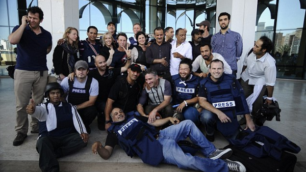Journalists celebrate after being held hostage in Libya during the 2011 uprising. (AFP/File)