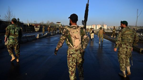 Afghan security personnel gather near the scene of a suicide bombing near the gate of Ministry of Defense in Kabul on February 27, 2016. (AFP/Wakil Kohsar)