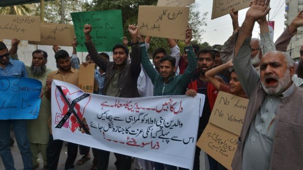 Pakistani demonstrators hold posters as they take part in a protest against Valentine's Day in Karachi on February 13, 2016. (AFP/Imran Ali)