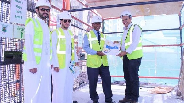 فريق إدارة البيئة والصحة والسلامة خلال توزيعهم انشرات التوعوية على العمل.