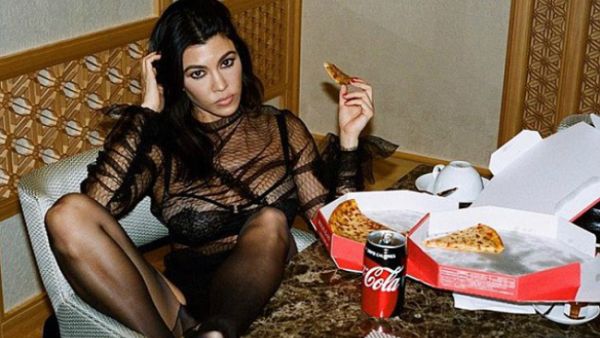 'Pizza party': Kourtney Kardashian shares racy pic on Instagram of her in a see-through lace top that shows that flashes her bra (Source: kourtneykardash - Instagram)