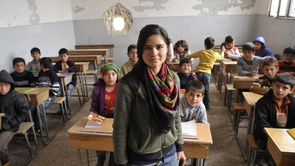 A Syrian Kurdish teacher and her students in Kobane.  (AFP/Michalis Karagiannis)