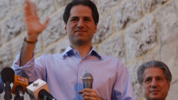 Lebanese MP Samy Gemayel waves to the crowd as his father, former president Amine Gemayel, stands behind him during celebrations by supporters of his party in the mountain resort of Bikfaya on June 8, 2009. (AFP/Joseph Barrak) Lebanese MP Samy Gemayel waves to the crowd as his father, former president Amine Gemayel, stands behind him during celebrations by supporters of his party in the mountain resort of Bikfaya on June 8, 2009. (AFP/Joseph Barrak)