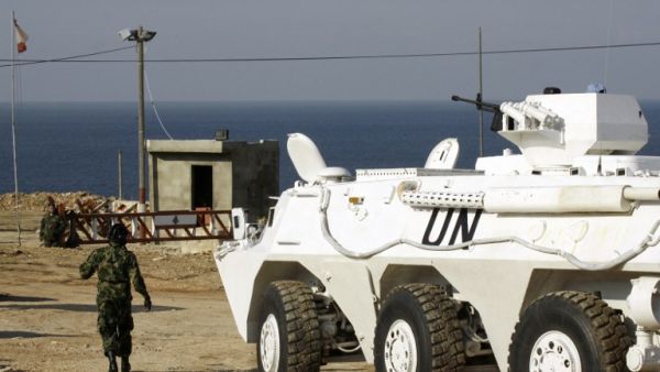 United Nations Interim Force in Lebanon (UNIFIL) troops stand guard at the Ras al-Naqura checkpoint on the Lebanese-Israeli border on December 16, 2013 following crossfire between Israeli and Lebanese forces the previous evening. [AFP]