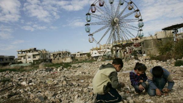  Palestinian children collect stones to be thrown at their friends as they play a 'war' game in the Palestinian refugee camp of Nahr al-Bared, 2009.  JOSEPH EID/AFP/Getty Images)