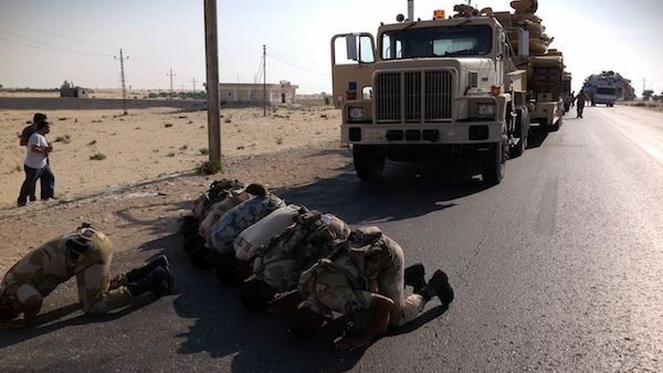 Egyptian soldiers pray as they are deployed in the northern Sinai town of Al-Arish on July 16, 2013. (Source: AFP/STR)