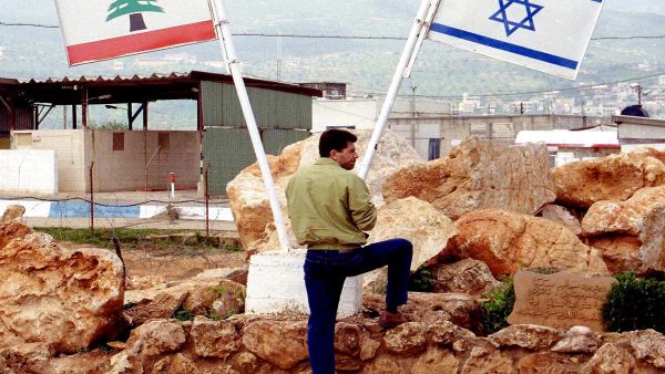 An off-duty Israeli soldier looks across the Israeli-Lebanon border (Shutterstock/Northfoto)