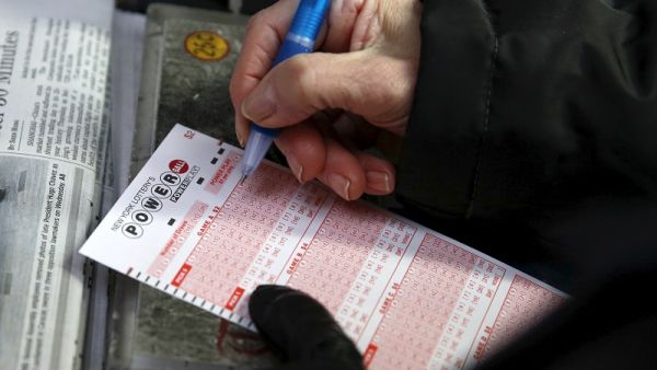 A woman fills out a ticket for the Powerball lottery draw at Times Square in the Manhattan. (AFP/ File)