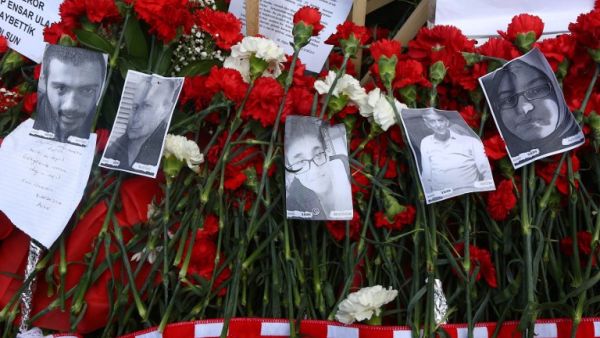 Flowers and photos are displayed in remembrance of the victims of the attack on March 17, 2016 in Ankara, on the site of the blast that killed 35 people on March 13. (AFP/Adem Altan)