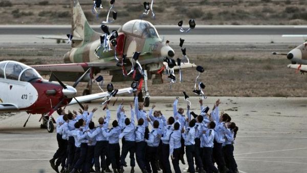 Israeli pilots throw their hats in the air as they celebrate at their graduation ceremony. (AFP)
