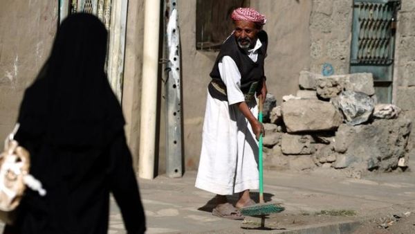 A Yemeni man sweeps a street during the "Sharik (participate), My contribution builds Yemen" cleaning campaign in the capital. (AFP PHOTO/ MOHAMMED HUWAIS)