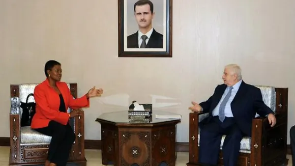 Syrian Foreign Minister Walid Muallem (R) speaks with UN humanitarian chief Valerie Amos during a meeting in Damascus on December Saturday. Muallem called on the United Nations to intervene and lift sanctions imposed on Syria, SANA reported. (AFP PHOTO/HO/SANA) 