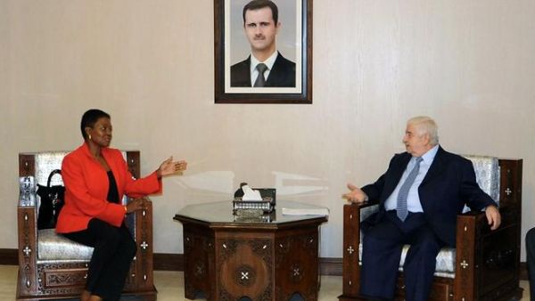 Syrian Foreign Minister Walid Muallem (R) speaks with UN humanitarian chief Valerie Amos during a meeting in Damascus on December Saturday. Muallem called on the United Nations to intervene and lift sanctions imposed on Syria, SANA reported. (AFP PHOTO/HO/SANA) 