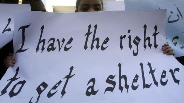A Palestinian girl, who along with other families who fled the Yarmuk Palestinian refugee camp in the Syrian capital of Damascus, holds up a sign during a rally in front on the United Nations Relief and Works Agency (UNRWA) offices in the Palestinian refugee camp of Ain El-Helweh on the outskirts of the southern Lebanese city of Sidon on Tuesday (AFP PHOTO/MAHMOUD ZAYYAT)